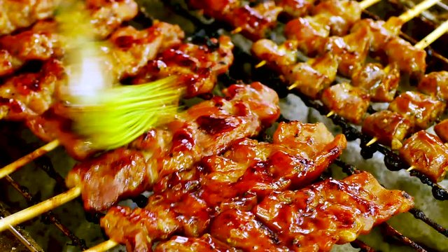 Food Video Satay Pork or Chicken Be prepared with bamboo and grill it on a wood stove or a charcoal oven and a seasoned seasoning at street food Satay is born from Java Island or Sumatra in Indonesia.