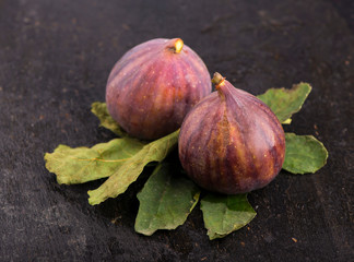 Fresh figs on black background close up