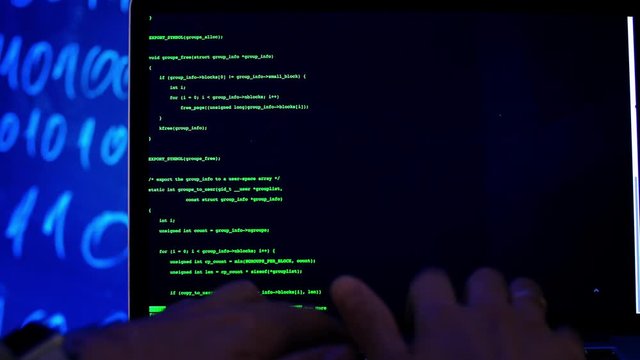 Close-up hands typing programming code. Programmer Developer hacking or writes the source code of the software. Man working with computer.