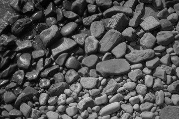 black and white rocks in the ocean textured background