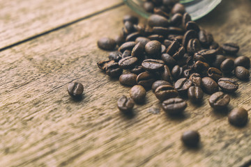 Coffee Beans on the Old Wood Table. Vintage Retro Style Picture Added.