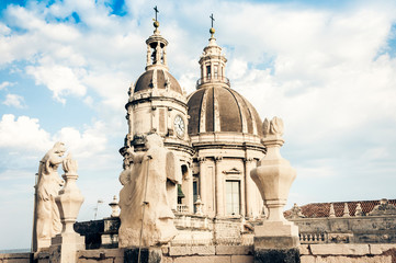 Fototapeta na wymiar Domes of the Cathedral dedicated to Saint Agatha. The view of the city of Catania, Sicily, Italy .