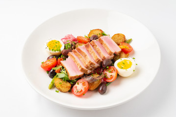 Salade niçoise on the white plate