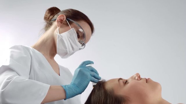 Cosmetologist performs prp plasma injections for hair regrowth