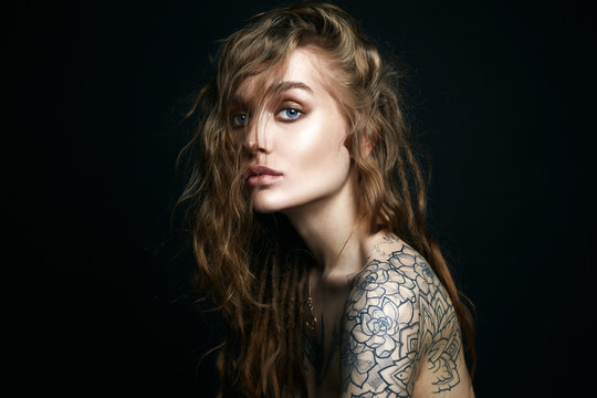 Sexy Young Woman with Tattoo. Fashion Portrait