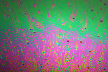 Multicolored rainbow soap bubble, psychedelic background. Abstract liquid colors and texture.