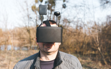 A man manages FPV drone in VR glasses