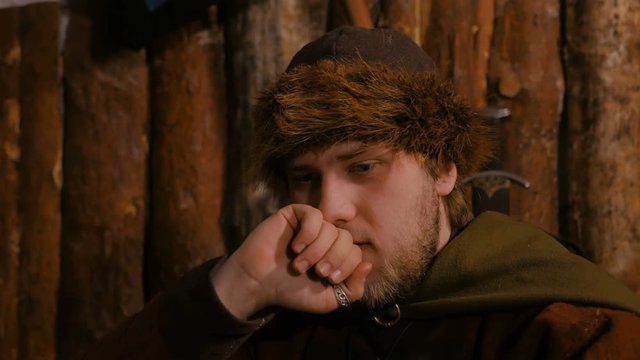 Portrait of man in russian ethnic suit playing board game like chess. Folk, loss and fiasco concept