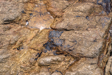 .top view of wave hit rock on the beach texture of rock when it wet and dry