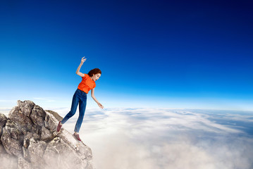 Woman stumbled on the rocks and going to falls down.