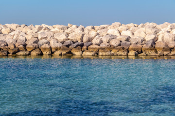 Beautiful city beach in the bay with clear water and white sand.