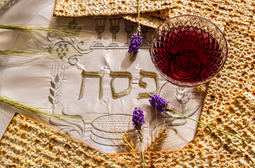 Traditional unleavened bread food - matzah and glass of red wine for Jewish Passover Holiday....