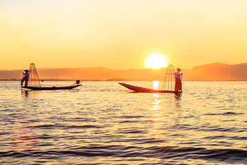 Naklejka na ściany i meble Myanmar travel attraction landmark - Traditional Burmese fisherman at Inle lake, Myanmar famous for their distinctive one legged rowing style