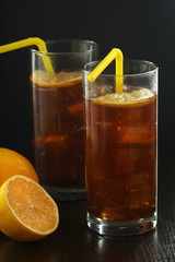 Glasses with cuba libre cocktail or cola with ice or cold tea with lemon