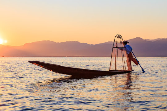 Myanmar travel attraction landmark - Traditional Burmese fisherman at Inle lake, Myanmar famous for their distinctive one legged rowing style