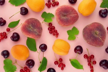 Fruit berry pattern. Ripe apricots and peaches, sweet cherry and red currants with green leaves on a pink background.Summer fruits. .Summer season.summer fruit  phone wallpaper 