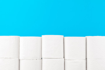 Toilet paper stack on bright blue background