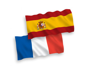 National vector fabric wave flags of France and Spain isolated on white background. 1 to 2 proportion.