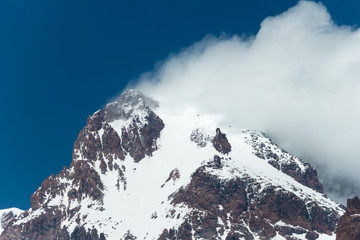 Fototapeta na wymiar Kazbegi, Georgia - Jun 29 2018: Mount Kazbek (5047m). a famous landscape in Kazbegi, Mtskheta-Mtianeti, Georgia.