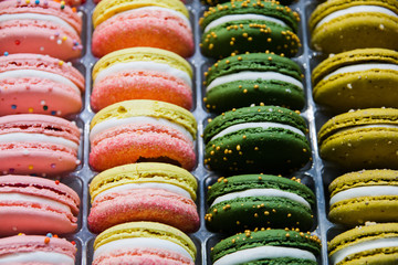 Bright colorful beautiful macaroons with tender and flavorful cream. The contrast of colors and the ideal form, selective focus