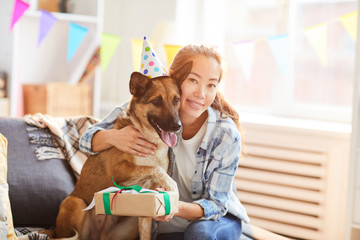 Portrait of Asian woman hugging gog while celebrating Birthday, copy space