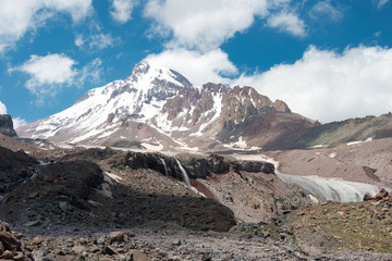 Kazbegi, Georgia - Jun 29 2018: Mount Kazbek (5047m) at Gergeti Glacier. a famous landscape in Kazbegi, Mtskheta-Mtianeti, Georgia.