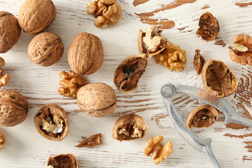 Tasty walnuts on white wooden table