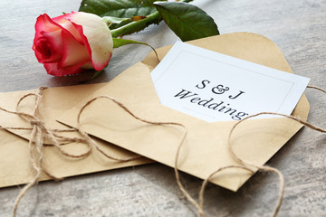 Wedding invitation and flower on table