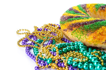 Festive cake for Mardi Gras (Fat Tuesday) holiday with beads on white background © Pixel-Shot