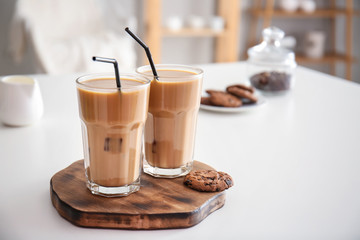 Glasses of tasty frappe coffee on white table
