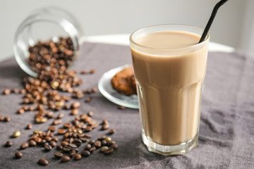 Glass of tasty frappe coffee on table
