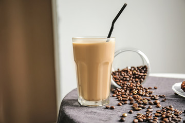 Glass of tasty frappe coffee on table