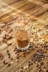 Glass of tasty frappe coffee on wooden table