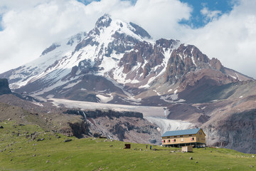 Kazbegi, Georgia - Jun 29 2018: Mountain hut at Mount Kazbek (5047m). a famous landscape in Kazbegi, Mtskheta-Mtianeti, Georgia.