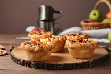 Tasty apple pies on wooden board