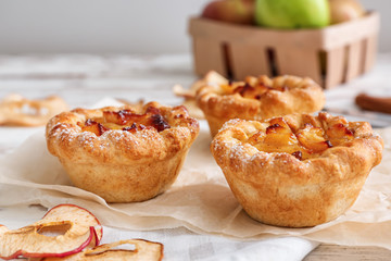 Tasty apple pies on table