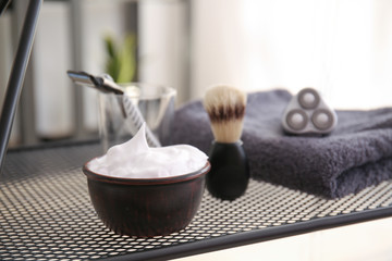 Shaving foam with accessories on table