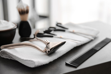Hair cutter with towel and accessories on table