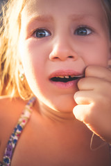 The process of removing a baby tooth using a thread