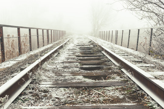 Rails in hoarfrost. Misty autumn morning.