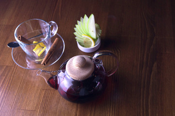 glass teapot glass cups and lemon brown table