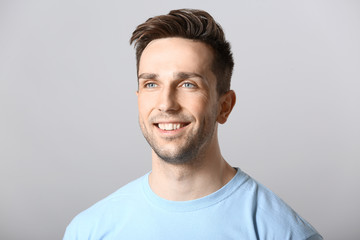 Fototapeta premium Portrait of handsome man on grey background