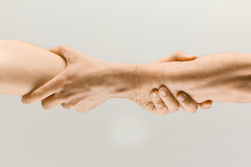 Stronger together. Male hands demonstrating a gesture of holding and strong isolated on gray studio...