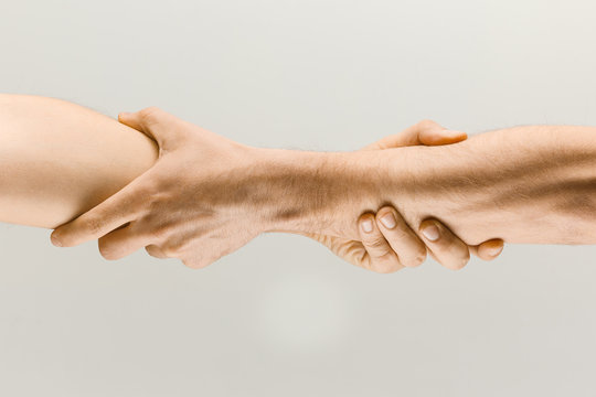 Stronger together. Male hands demonstrating a gesture of holding and strong isolated on gray studio background. Concept of human relations, friendship, partnership, business, Copyspace.