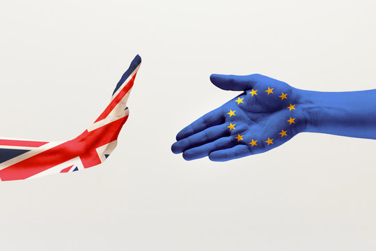 Misunderstandings and intense conversation. Male hands colored in United Kingdom and European Unity flags isolated on white studio background. Concept of political, economical, social, disagreement.