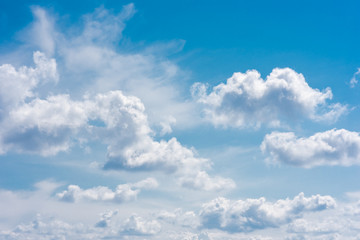 Naklejka na ściany i meble Beautiful white cumulonimbus clouds against the background of the bright blue sky