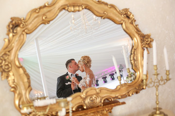 Beautiful wedding couple posing in mirror