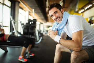 Lifestyle portrait of handsome muscular man after the training in the sport gym - obrazy, fototapety, plakaty