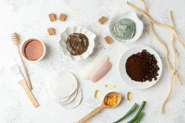 Fototapeta na wymiar Homemade skin care and body scrubs and mask with natural ingredients aloe vera, lemon, coffee, sugar, clay, honey set up on white wooden background with flat lay