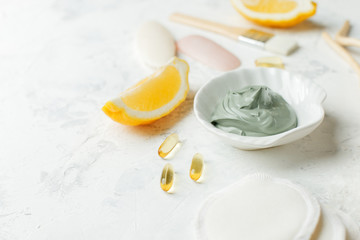 home made spa cosmetic with citrus, volcanic clay, soap, essential oil on white gray background top view, organic natural hegiene cosmetic concept, copy space